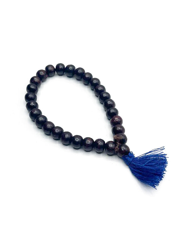 Bracciale Mala in legno scuro con nappa azzurra